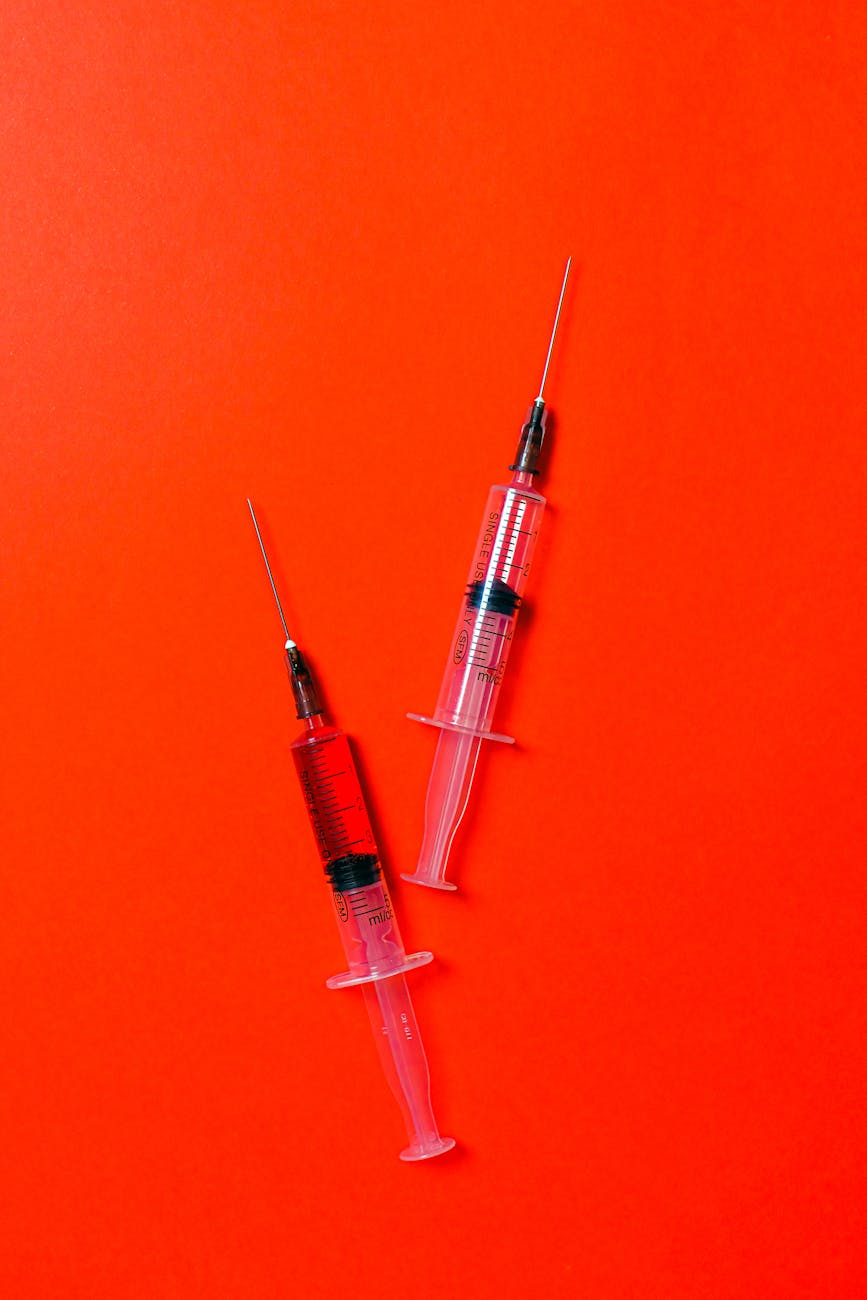 syringes on red background